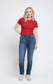 Woman wearing a red t-shirt and blue jeans on a white background